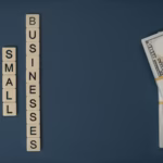 Conceptual image of supporting small businesses with financial resources using money and letter tiles.