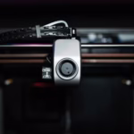 Macro shot of a 3D printer nozzle highlighting technology and precision.