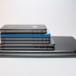 Stacked modern smartphones and tablets showcasing sleek design. Perfect tech background.